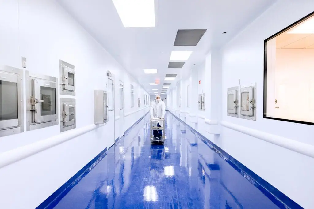 Image showing employee pulling cart in cleanroom